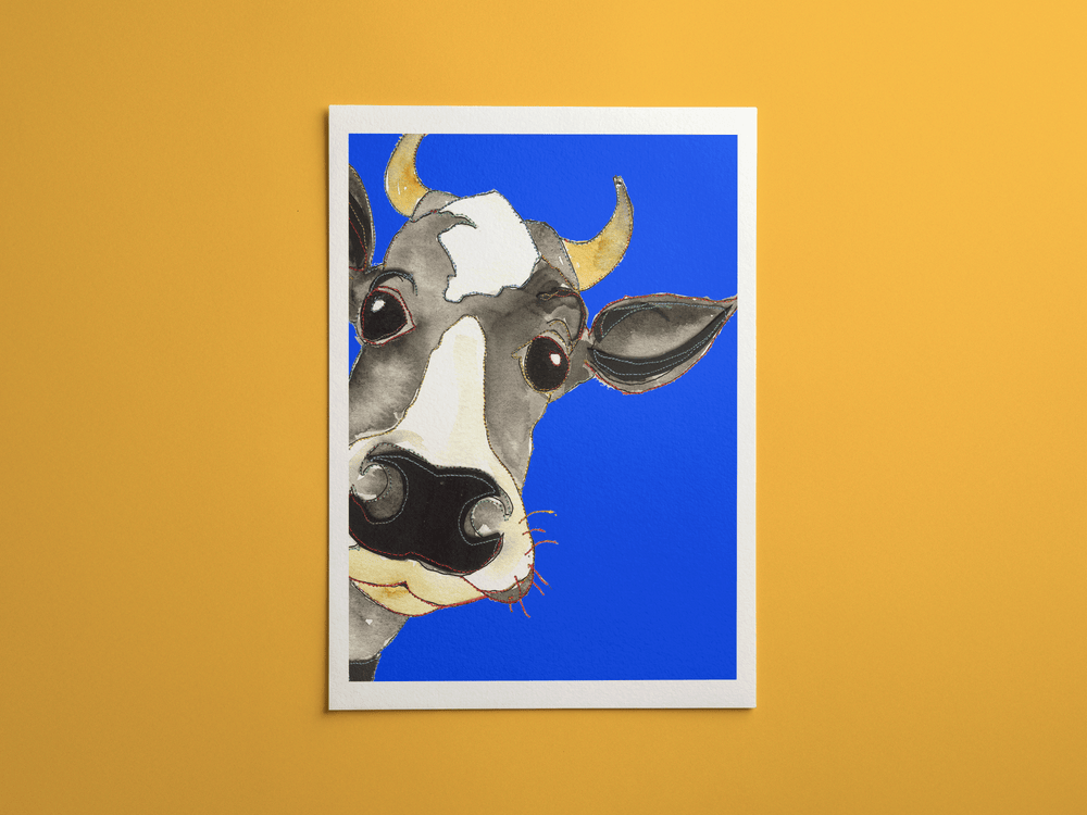 Blue Cow print, framed on a wall