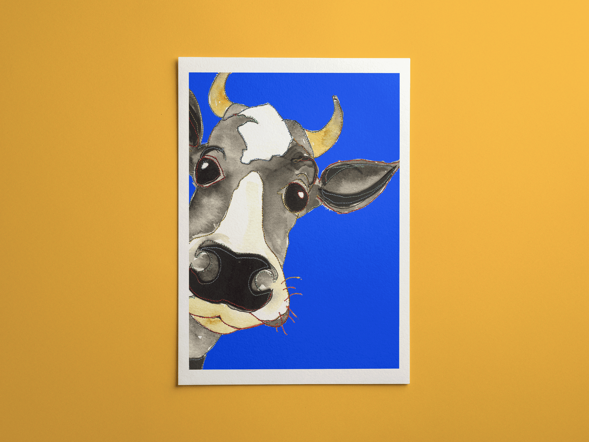 Blue Cow print, framed on a wall